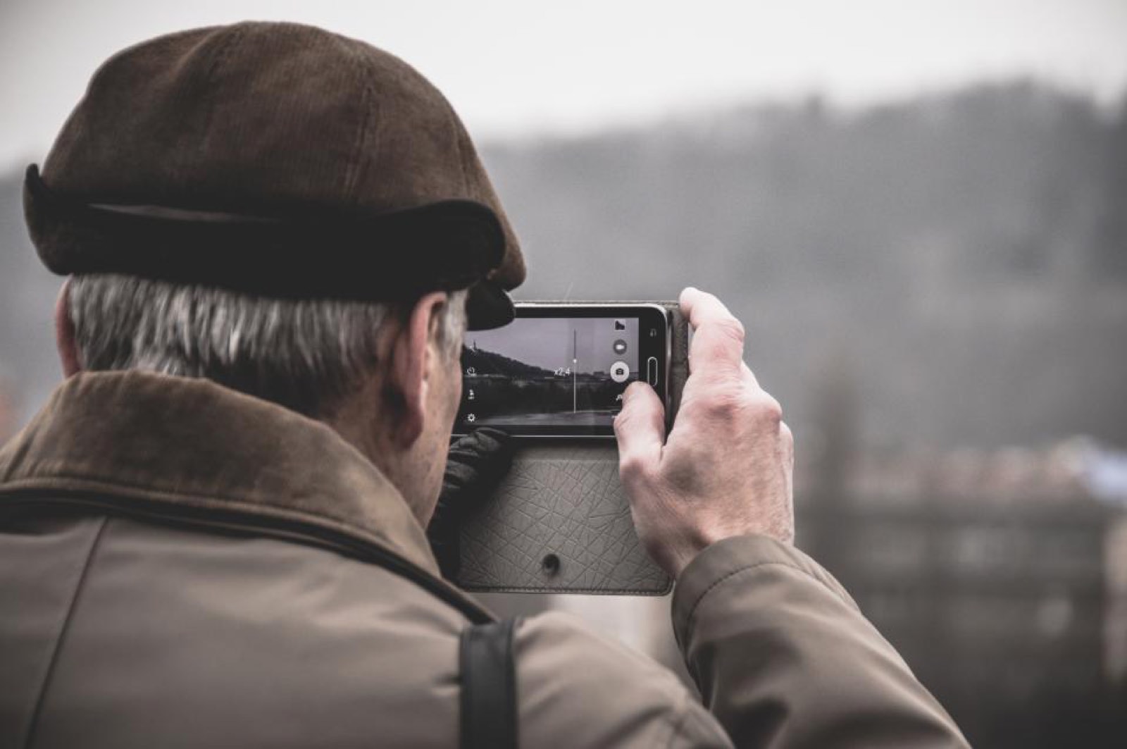 An older man taking a photo