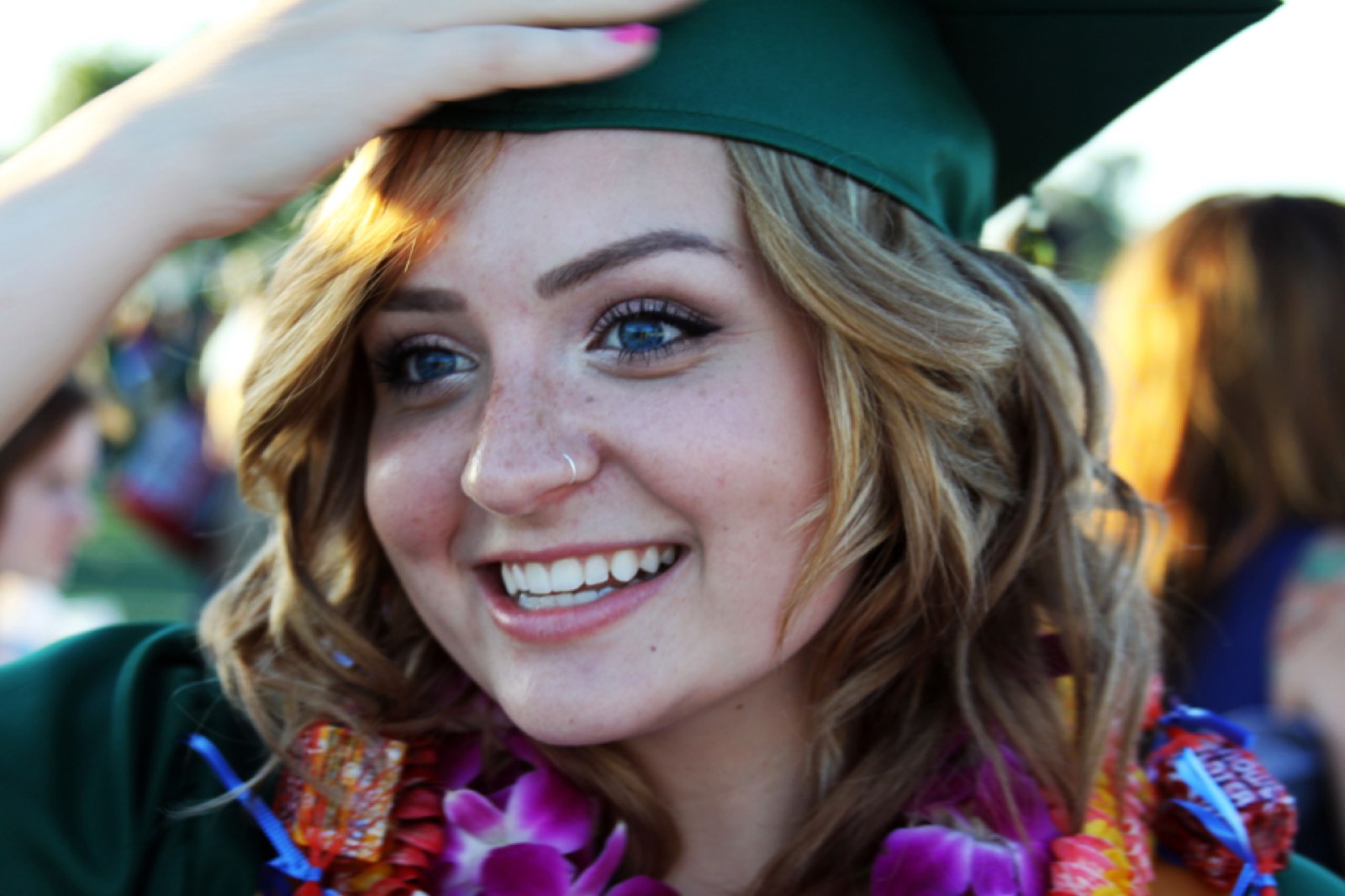 A smiling graduate in a cap