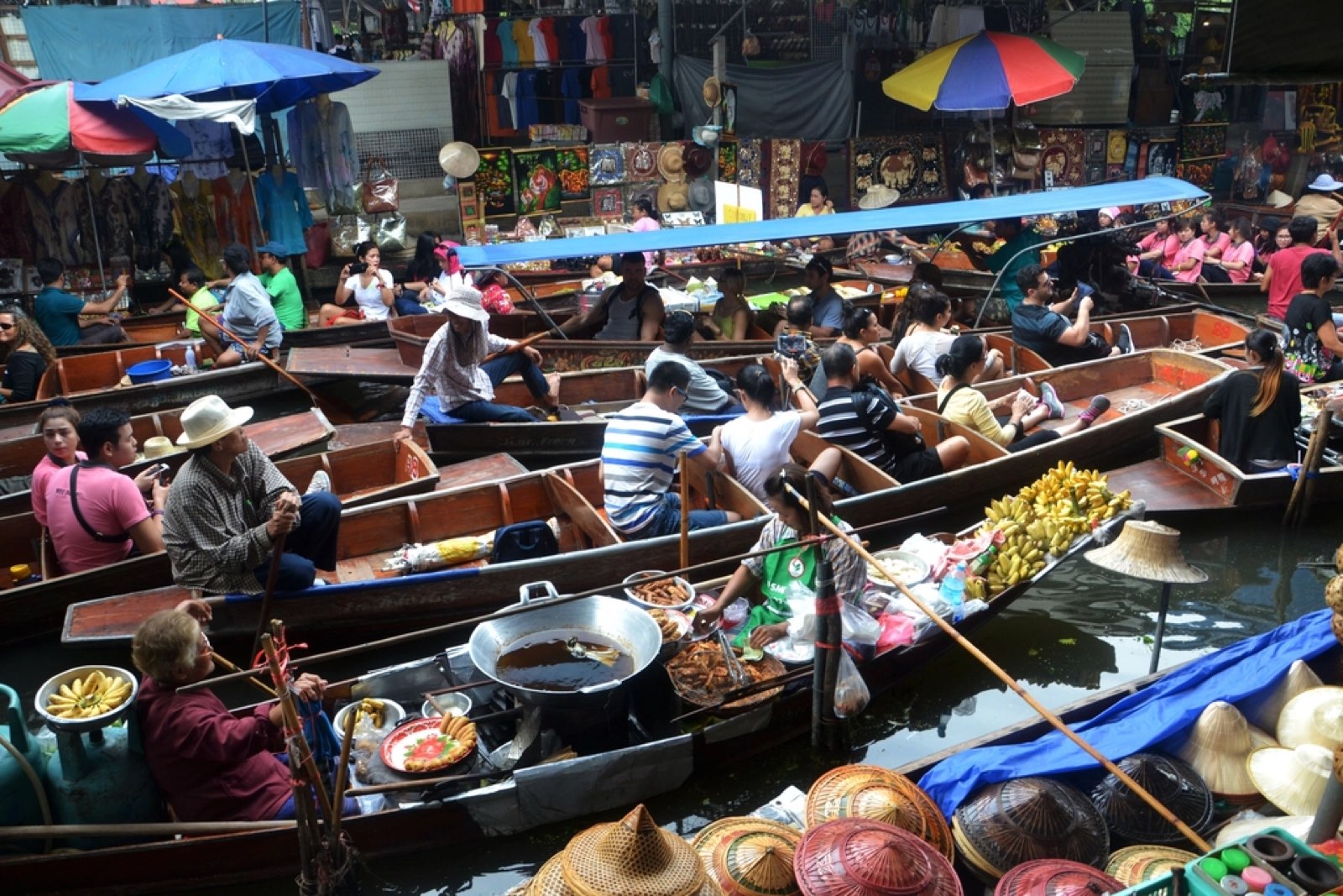 A busy floating market with boats of produce