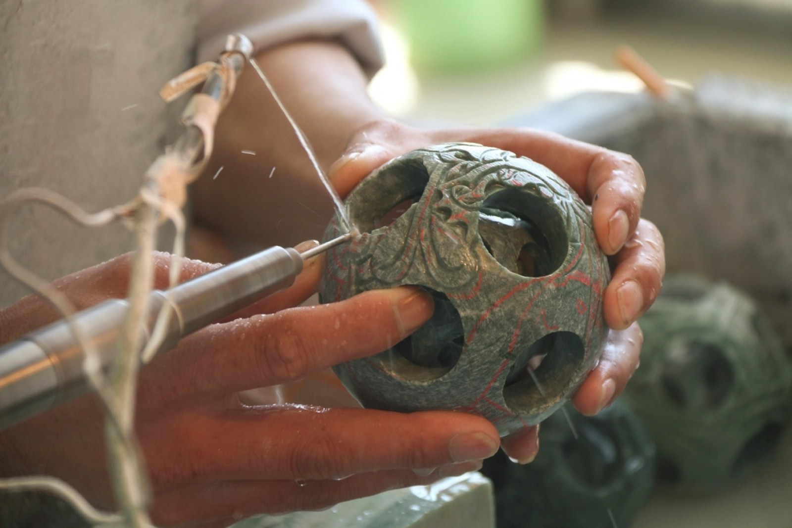 A craftsman carving stone by hand