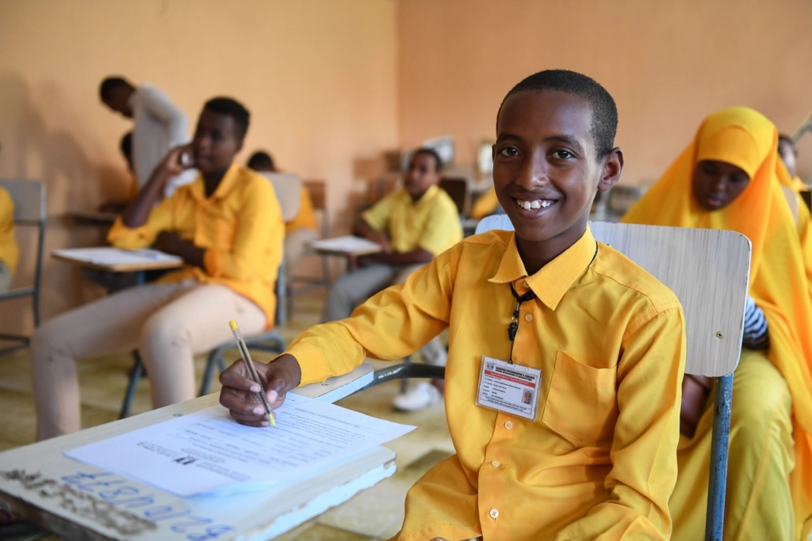 A smiling student at his desk
