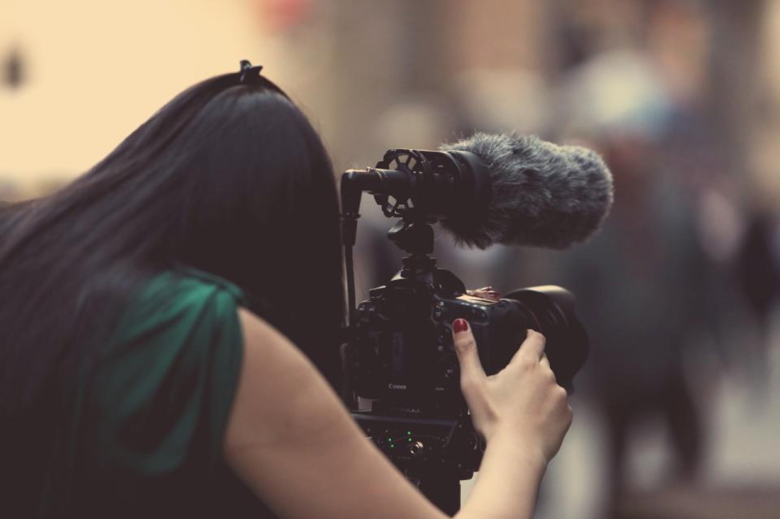 A woman filming with a video camera