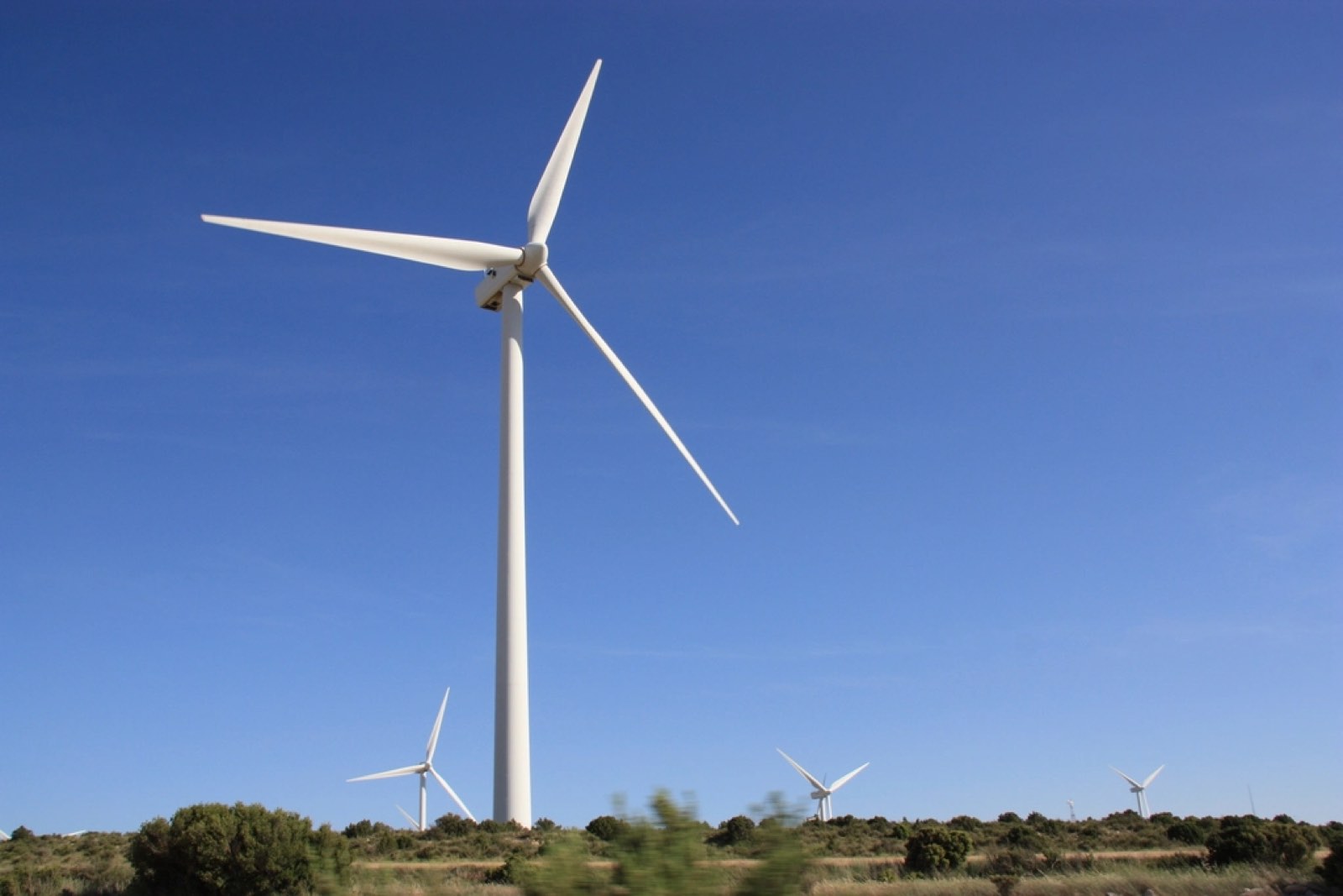 A wind turbine against a blue sky