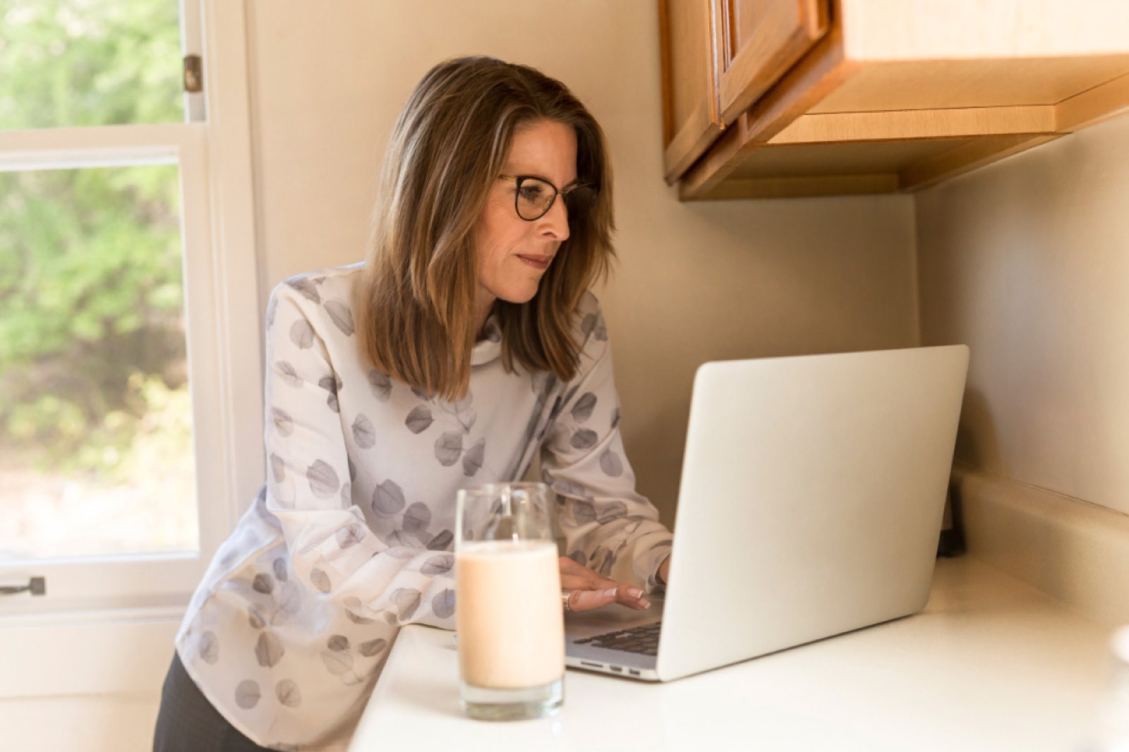 A woman working on a laptop at home